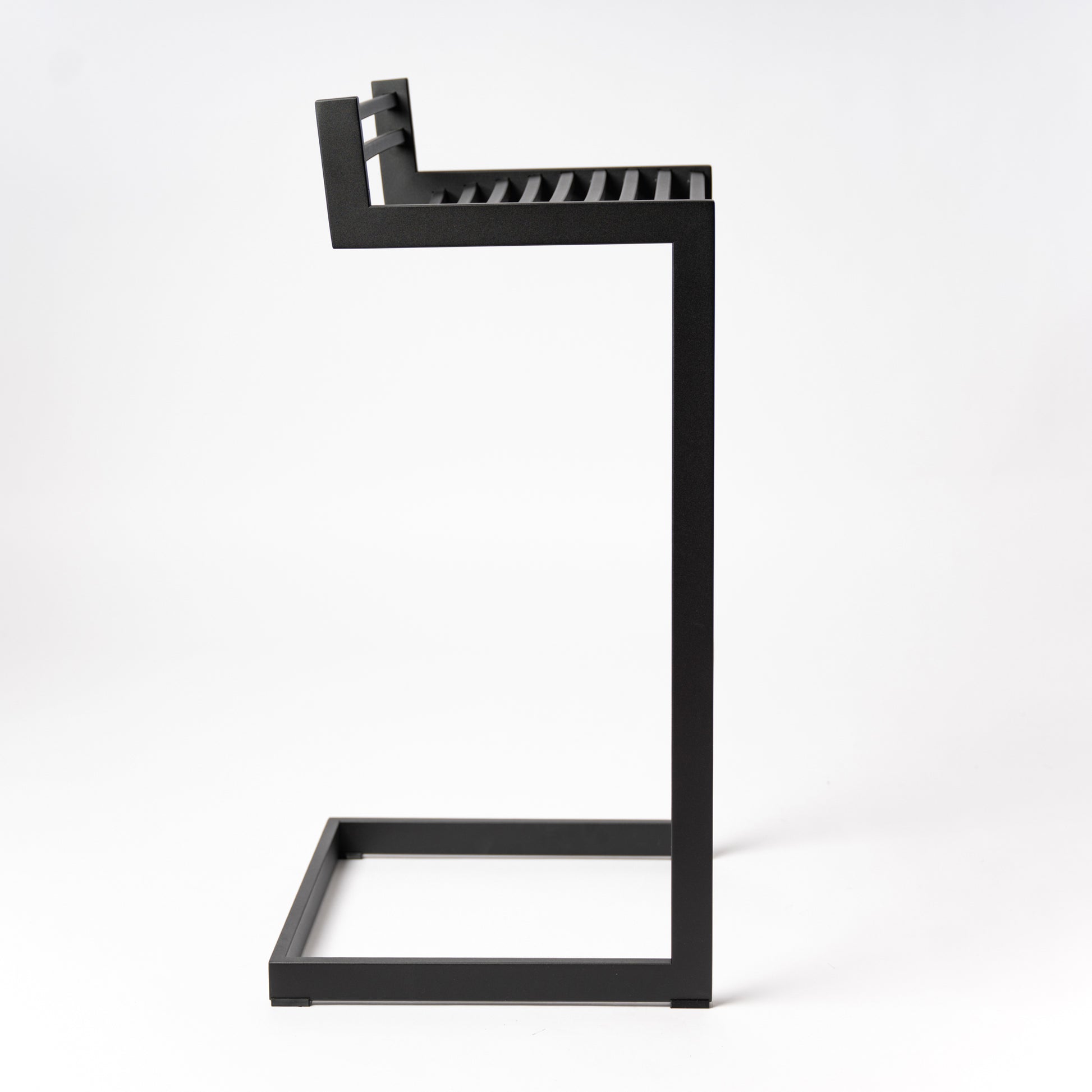 Side profile of Forma b Metalinea Black bar stool showing distinctive lowercase 'b' shape design, perfect for kitchen islands