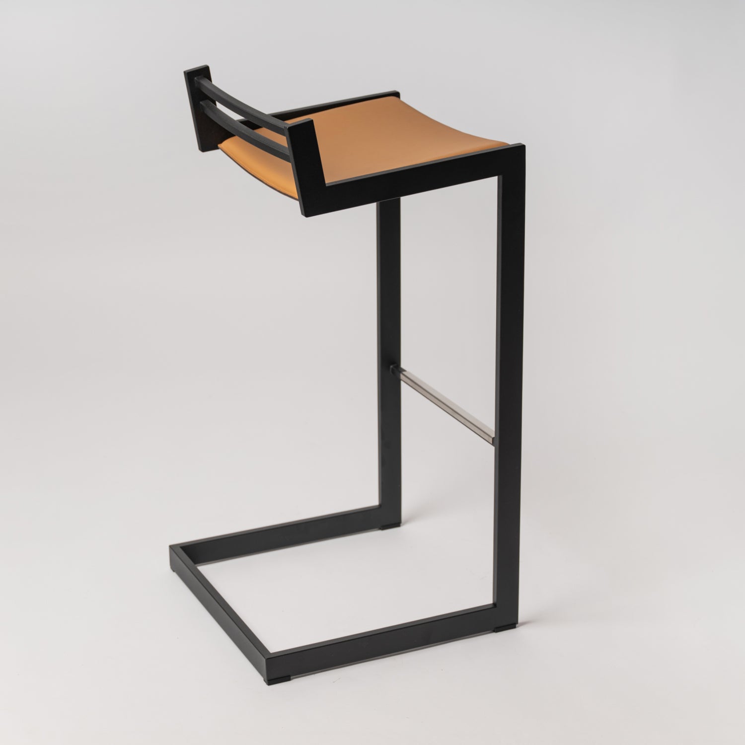 Minimalist Forma b stool - rear view of Camel Nappa leather craftsmanship and Black stainless steel construction, suitable for both bar and counter heights