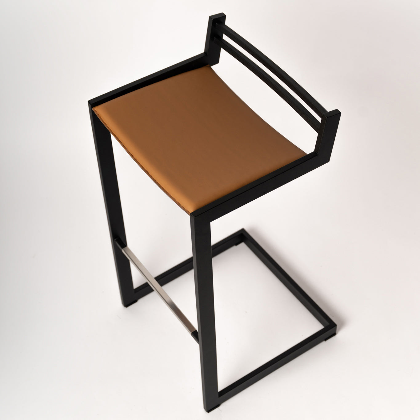 Handcrafted Scandinavian Forma b bar stool - top angle showcasing stainless steel frame and premium brown Nappa leather upholstery, available in bar and counter height