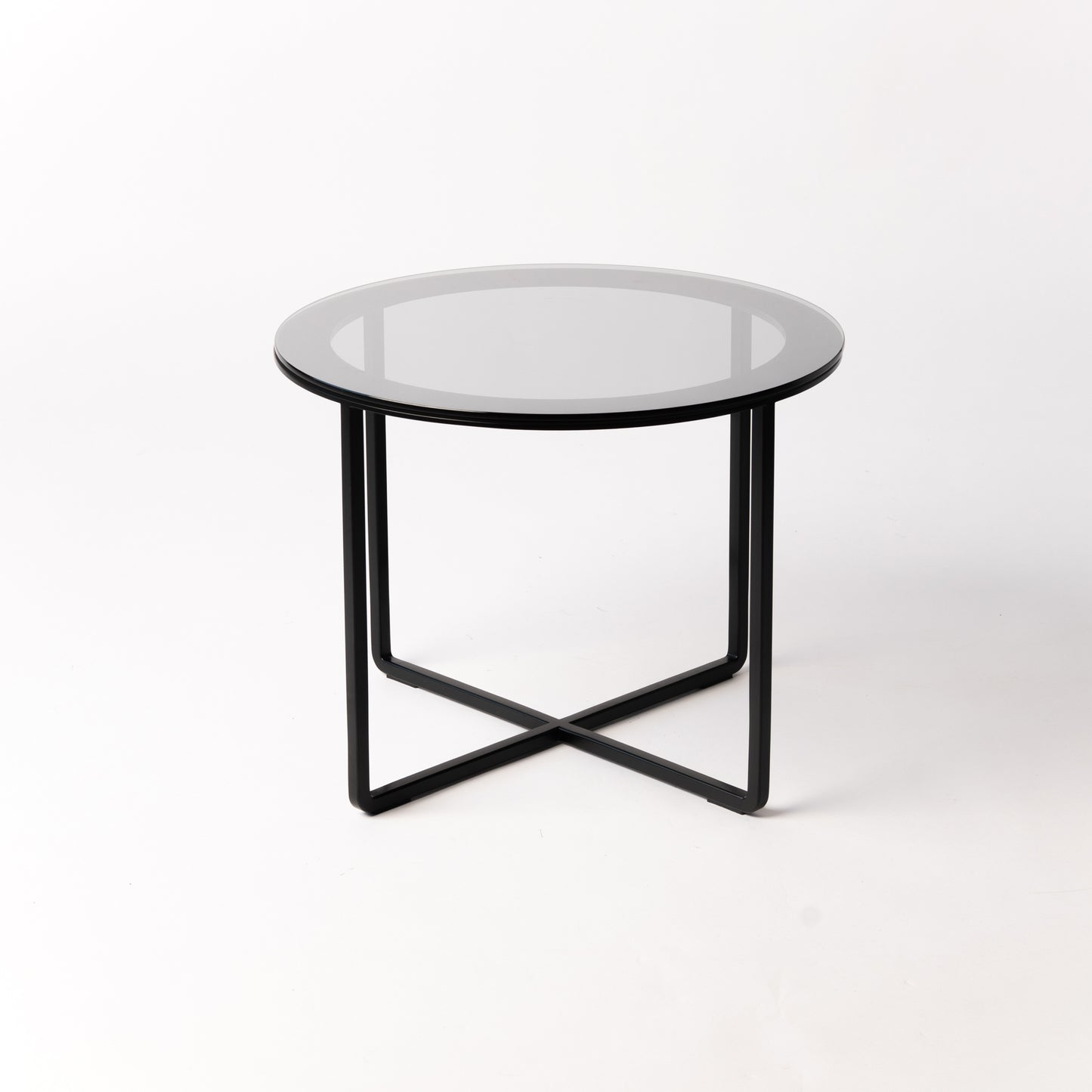 Minimalist Circo X Side Table - side angle highlighting the architectural black steel base supporting glass top